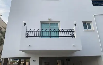 a white building with a balcony on top of it at Kika Court 2 in Paralimni