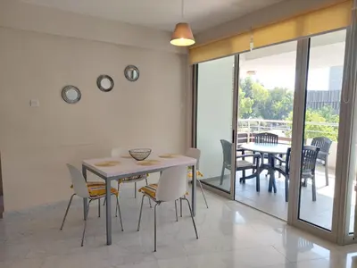 a dining room with a table and chairs at Amathousa Coastal Heights D202 in Limassol