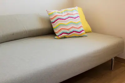 a colorful pillow sitting on top of a couch at Amathousa Coastal Heights D202 in Limassol