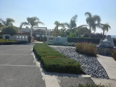 a walkway with a statue and a building and palm trees at Amathousa Coastal Heights D202 in Limassol