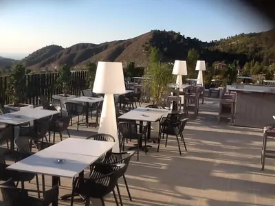 a group of tables and chairs on a patio at Crystal Hotel in Kakopetria