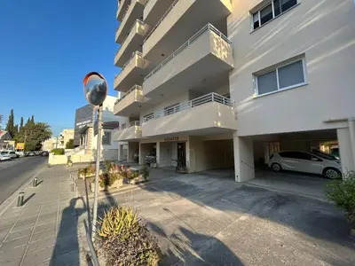 a building with a car parked in front of it at Apartment Capella, Larnaca in Larnaka