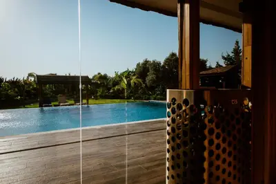 a view of a swimming pool through a window at Grand Mansion Countryhouse & Spa in Phrenaros