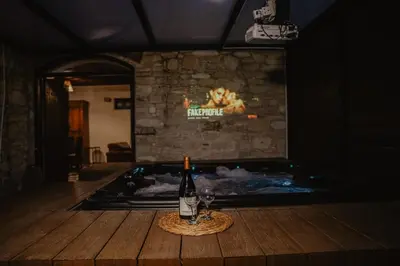 a bottle of wine sitting on a table next to a hot tub at The Stonehouse Suites with Private Bath Spas in Limassol