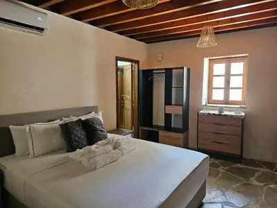a bedroom with a large white bed in a room at The Stonehouse Suites with Private Bath Spas in Limassol