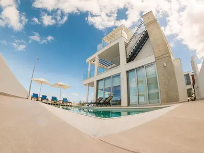 a house with a swimming pool in front of it at Imperial Jade Villas Gold Emerging Villas 1 in Protaras