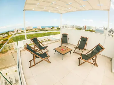a balcony with chairs and a table on a building at Imperial Jade Villas Gold Emerging Villas 1 in Protaras