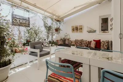 a room filled with lots of furniture and plants at Hotel Opera in Larnaka