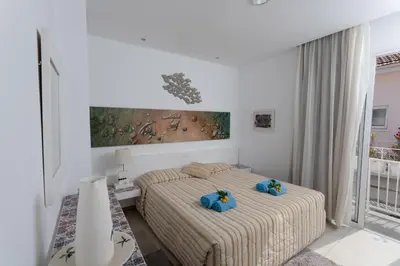 a bedroom with two beds with blue towels on them at Hotel Opera in Larnaka