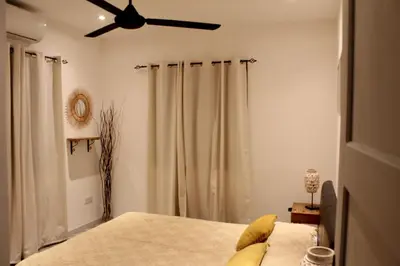 a bedroom with a bed and a ceiling fan at skeleas 10 in Pissouri