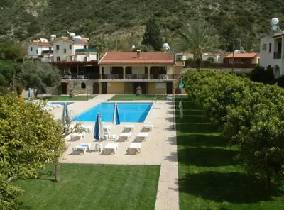 a resort with a swimming pool and a house at skeleas 10 in Pissouri