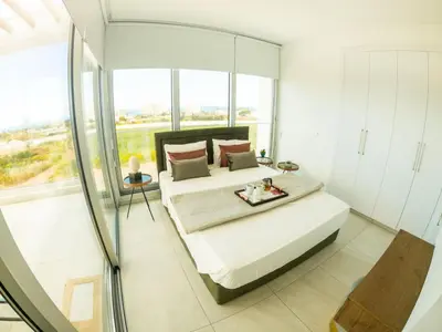 a bedroom with a bed and a glass shower at Imperial Jade Villas Gold Emerging Villas 3 in Protaras