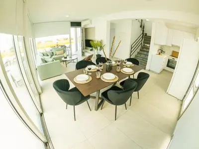 a dining room with a table and chairs at Imperial Jade Villas Gold Emerging Villas 3 in Protaras