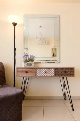 a dressing table with a mirror on a wall at NISSI BEACH POOL VIEW APARTMENT FREE WIFI in Ayia Napa