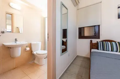 a bathroom with a toilet and a sink at Villa Alexandra by Ezoria Villas in Ayia Napa