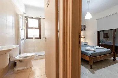 a bathroom with a bed and a toilet and a sink at Villa Alexandra by Ezoria Villas in Ayia Napa