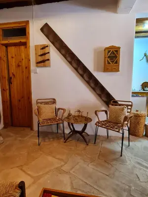 a room with a table and chairs and a staircase at Kassandras place in Omodos village in Omodos
