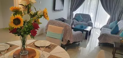 a living room with a table with a vase of flowers at Casa Di Gio in Tersephanou
