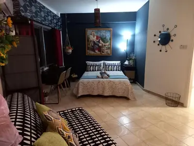 a bedroom with a bed and a blue wall at Artemis Boutique Apartment 2 in Limassol