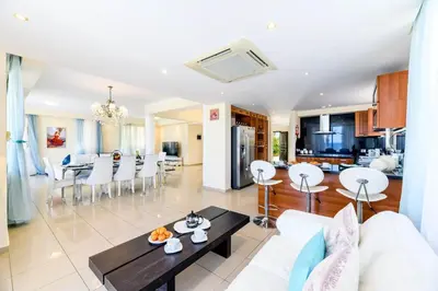 a living room with a couch and a table at Royal Beachfront Villa in Protaras