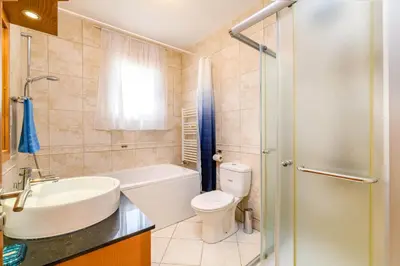 a bathroom with a toilet and a sink and a shower at Royal Beachfront Villa in Protaras