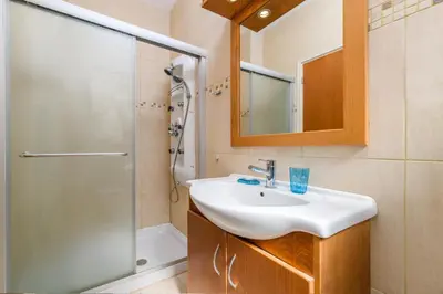 a bathroom with a sink and a shower at Royal Beachfront Villa in Protaras