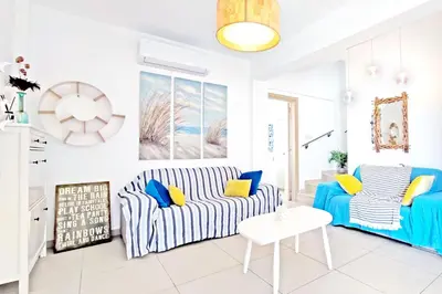 a living room with a couch and a table at Nissini Shell, 3 bedroom villa with private pool at Nissi Beach in Ayia Napa