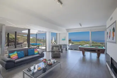 a living room with a couch and a pool table at Chloe Luxury Villas in Protaras