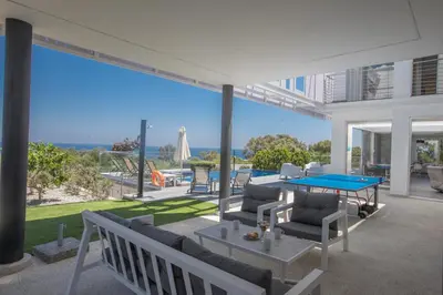a living room with a ping pong table on a patio at Chloe Luxury Villas in Protaras