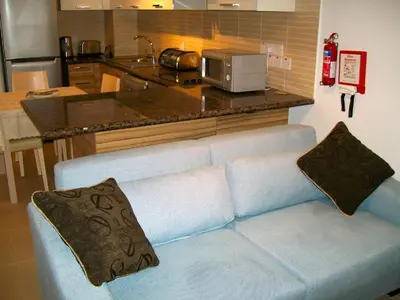 a living room with a blue couch in a kitchen at A209 Coralli Spa, Cyprus - Med View Studio in Protaras