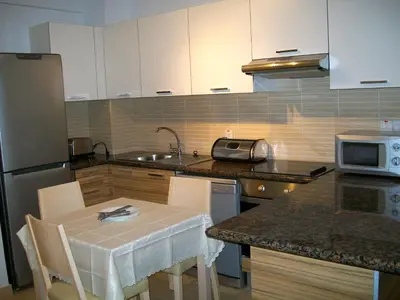 a kitchen with a table and a sink and a microwave at A209 Coralli Spa, Cyprus - Med View Studio in Protaras