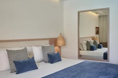 a bedroom with a bed and a large mirror at Atlantica Aeneas Resort in Ayia Napa