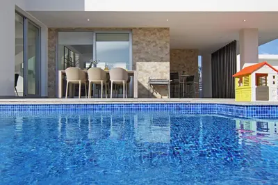 a swimming pool in a house with a house at Villa Harmonia in Protaras