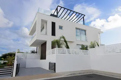 a white house with a black roof at Villa Harmonia in Protaras