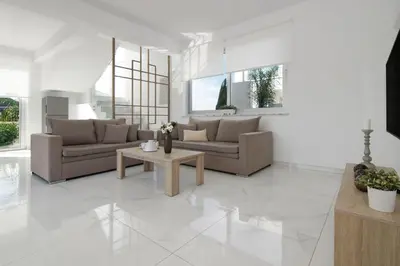 a living room with two couches and a table at Villa Harmonia in Protaras