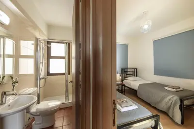 a bathroom with a bed and a sink and a toilet at Villa Ionion 27 in Ayia Napa