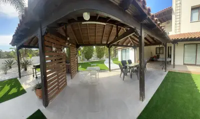 a pergola with a table and chairs on a patio at Leo's Paradise in Protaras
