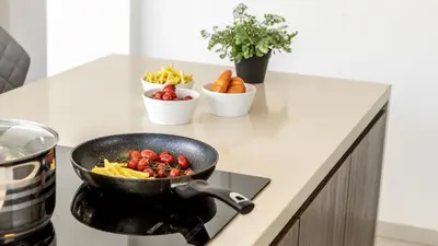 a frying pan on a stove with fruits and vegetables at Diamond villas in Protaras