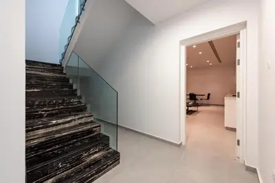 a staircase in a house with a glass wall at Seafront Villa Maya by Ruidoso Luxury in Ayia Napa