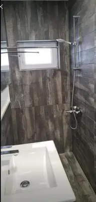 a bathroom with a white sink and a shower at Studio Anastasia in Limassol