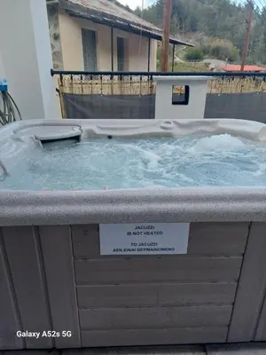 a hot tub with water on top of it at Love Holiday Suite 1 in Tris Elies