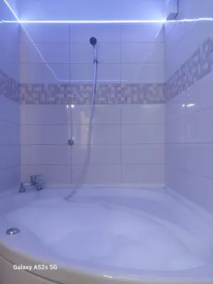 a bath tub with a shower in a bathroom at Love Holiday Suite 2 in Tris Elies