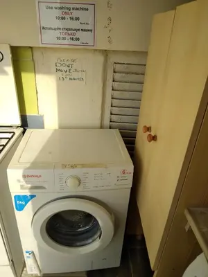 a washer and dryer in a small room at MERSINERA PARADISE GARDEN STARS HOUSE in Larnaka