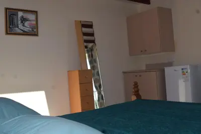 a kitchen with a green bed and a refrigerator at MERSINERA PARADISE GARDEN STARS HOUSE in Larnaka