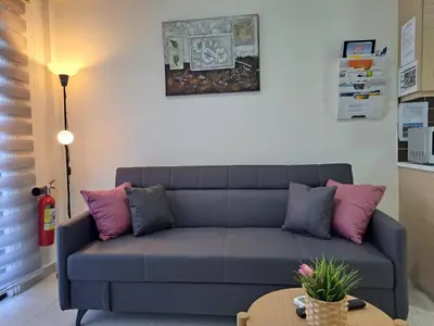 a living room with a couch and a table at House Near The Beach (Militsa & Aggeliki) in Pervolia