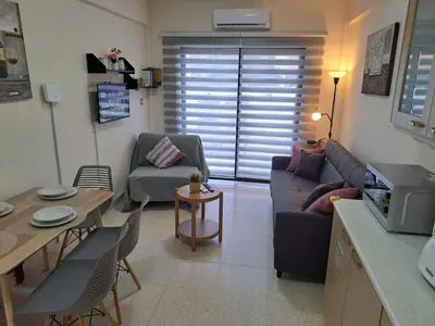 a living room with a couch and a table at House Near The Beach (Militsa & Aggeliki) in Pervolia