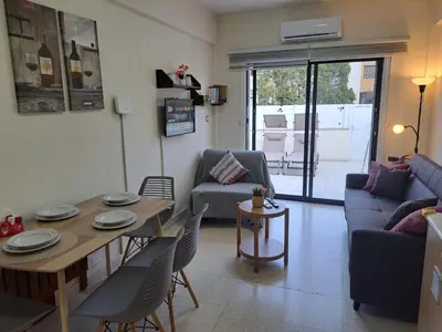 a living room with a table and a couch at House Near The Beach (Militsa & Aggeliki) in Pervolia