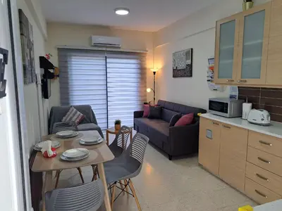 a small living room with a couch and a table at House Near The Beach (Militsa & Aggeliki) in Pervolia
