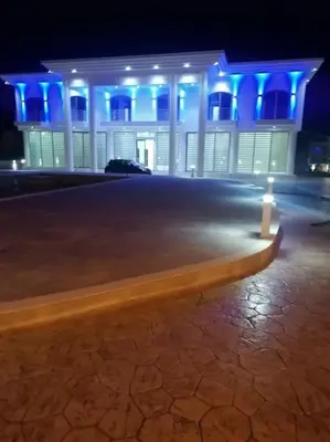 a bench in front of a building with blue lights at MAXOR PALACE in Protaras