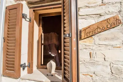 a window in a stone building with a sign on it at Our House in Vavla